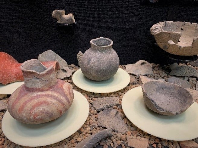 Pottery vessels of various colors that are pieced together and on display in Parkin Archeological State Park’s museum. 